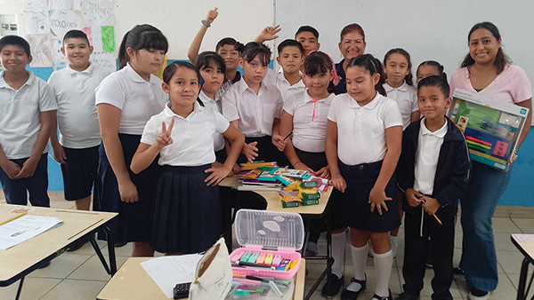Students smile with new school supplies donated by Lions, a simple act of service that empowers youth and strengthens communities.