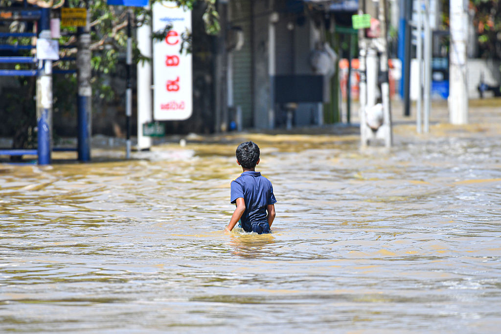 Young boy lost in high flood water