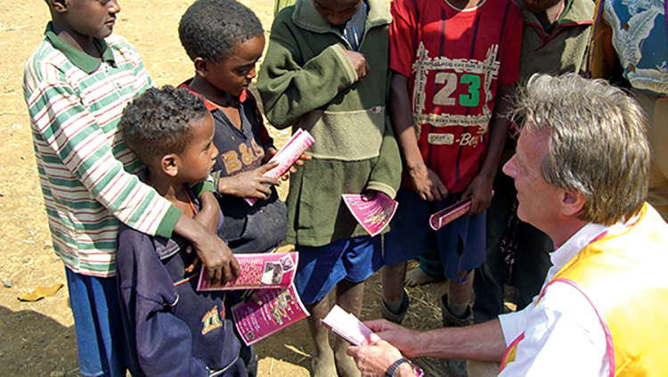 Man speaking to a group of children