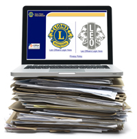 Laptop sitting on top of a file stack